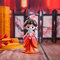 Macro detail of a cute chibi traditional Chinese doll holding a floral round fan - Yang Yuhuan