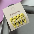 Detail shot of four yellow drop-shaped matte hair clips on white card for girls - Dark Yellow