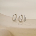 Close-up of silver polished hoop earrings with dimensions 1.3cm diameter and 0.2cm width - One Pair / Smooth Round Style-White Gold (E071230-2bkb)