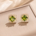 Elegant gold earrings set with emerald green center stone and sparkling zircon halo - Olive Green Stud Earrings