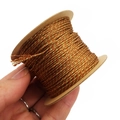 Detailed macro of 1mm gold and brown twisted metallic thread on a circular spool - Red Brown