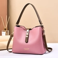 Pink fashion handbag with brown strap and gold hardware shown in a studio setting - Pink