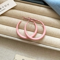Minimalist matte pink circular metal hoop earrings displayed in a luxury velvet box - Pink