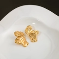 Minimalist gold leaf stud earrings with detailed vein texture on a white ceramic tray - Gold