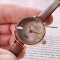 Close-up of vintage quartz watch with brown leather strap and rose gold case - Brown