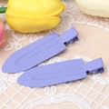 Detailed macro shot of a pair of purple matte finish duckbill hair clips on lace - Deep purple