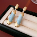 Detail of vintage matte gold long earrings with blue marble resin and zircon accents - Silver Earring Post-Blue / Blue