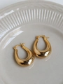 Orecchini a cerchio dorati spessi a forma di U su un piatto in ceramica decorato - Oro