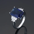 Silver ring featuring a large rectangular blue stone and round clear accents - Platinum Blue Diamond Ljz-232 / Adjustable Open