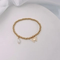 Detail of 18k gold plated beaded bracelet featuring a butterfly charm and white pearl - Gold - Hollow Butterfly