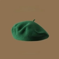 Close-up of wool texture on dark green beret with high-quality embroidery detail - One Size / Green
