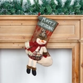 Christmas stocking with snowman doll ornament and red plaid pattern on a fireplace - Long Leg Style Snowman