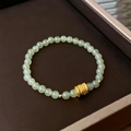 Light green fluorite beaded bracelet featuring a gold-toned barrel charm and ornate patterns - 70# Green Jade