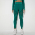 Detailed view of seamless knit yoga leggings featuring geometric laser-cut mesh ventilation - Dark Green