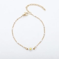Detail of 18K gold daisy bracelet with white enamel petals and small bead accents - Gold+White
