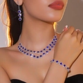Elegant silver jewelry set with blue gemstones and diamonds worn by a professional model - Necklace + Earrings + Bracelet / Blue Gem 3-Piece Set(DTN14026404-3BU)