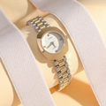 Elegant two-tone gold and silver quartz watch for women on a soft warm fabric background - White Dial