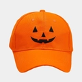 Close-up of Jack-o'-lantern embroidery and cotton texture on orange Halloween baseball cap - Adjustable / Orange Red