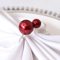 Silver napkin ring featuring two glossy red pearl beads on a white folded cloth - Bright Red (Silver Ring)