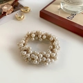 Elegant off-white faux pearl braided hair tie used as a bracelet or scrunchie accessory - Beige Pearl Scrunchie