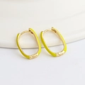 Detailed macro view of gold oval earrings with vibrant yellow enamel finish - Yellow