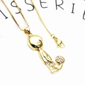 Macro shot of gold-plated soccer boy pendant necklace with shimmering white zircons - Football Boy / Pendant And Necklace