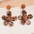 Macro detail of brown leopard print resin flower earrings on a white ceramic dish - Silver Earring Post - Coffee