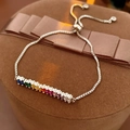 Detailed close-up of rainbow zircon bar bracelet on luxury brown jewelry gift box - Silver Rainbow