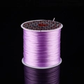 Purple crystal stretch cord spool for DIY jewelry making on a black reflective background - Light Purple