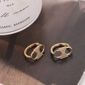 Elegant gold-plated bow link earrings with micro-set cubic zirconia on textured background - Gold