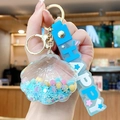 Llavero de concha azul con purpurina líquida y correa de goma con texto Happy - Azul
