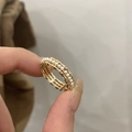 Detailed macro shot of a golden bamboo texture ring with pearl accents and adjustable band - Pearl Bead Style