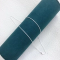 Detail of a thin silver water wave chain necklace wrapped on a green velvet jewelry roll - Twist Chain 45cm / Silver