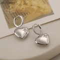 Elegant silver heart earrings with star-set zircon on a marble display stand - Heart Star Pattern / Silver