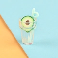Macro shot of miniature avocado drink cup with straw and resin slice decorations - Avocado