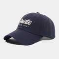 Detailed close-up of 3D letter embroidery on a navy blue cotton baseball cap - Navy Blue