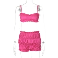 Detail view of pink satin two-piece set featuring camisole top and ruffled hem shorts - Rose Red
