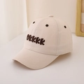 Detailed close-up of beige cotton baseball cap featuring brown 3D letter embroidery - 48-52cm (2-6 Years) / Beige