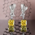 Radiant geslepen gele diamanten oorbellen met sprankelende strik en spiegelreflectie - Geel / Ijsbloem Slijpvorm