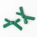 Detail of two green glossy bow-shaped alloy beads for DIY jewelry making and crafts - Green