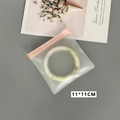 Detail of 11x11cm pink zip square jewelry storage bag with jade bracelet inside - 50 Silk Pink Frosted Zipper Bag / 11x11cm