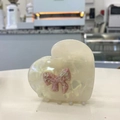 Close-up of heart-shaped cream acetate hair claw with pink marbled bow detail - Pearlescent White Heart Bow Claw (Approx. 7cm)