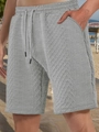 Detail of grey men's casual shorts featuring textured fabric and drawstring waist - Light Gray
