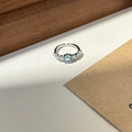 Silver adjustable ring featuring an oval light blue gemstone with small clear side stones - Silver Oval Light Blue Main Stone Adjustable Open Ring (J5749)