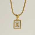 Golden necklace featuring a rectangular shell pendant with an inlaid letter K design - Letter K