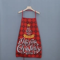 Close-up of red plaid Christmas apron with Merry Christmas print on a hanger - Red Black Plaid Star Wish Style