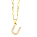 Close-up of gold-plated letter U pendant featuring shimmering cubic zirconia on a Figaro chain - Letter U
