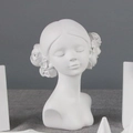 Detail shot of a white resin girl bust sculpture featuring delicate flower hair ornaments - Mini Girl Figure Statue