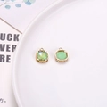 Square green mocha stone charms with golden openwork lace patterns on a ceramic plate - Malachite green