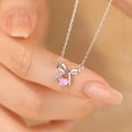 S925 silver necklace with sparkling bow pendant and pink heart crystal on hand - Silver/Pink Zirconia